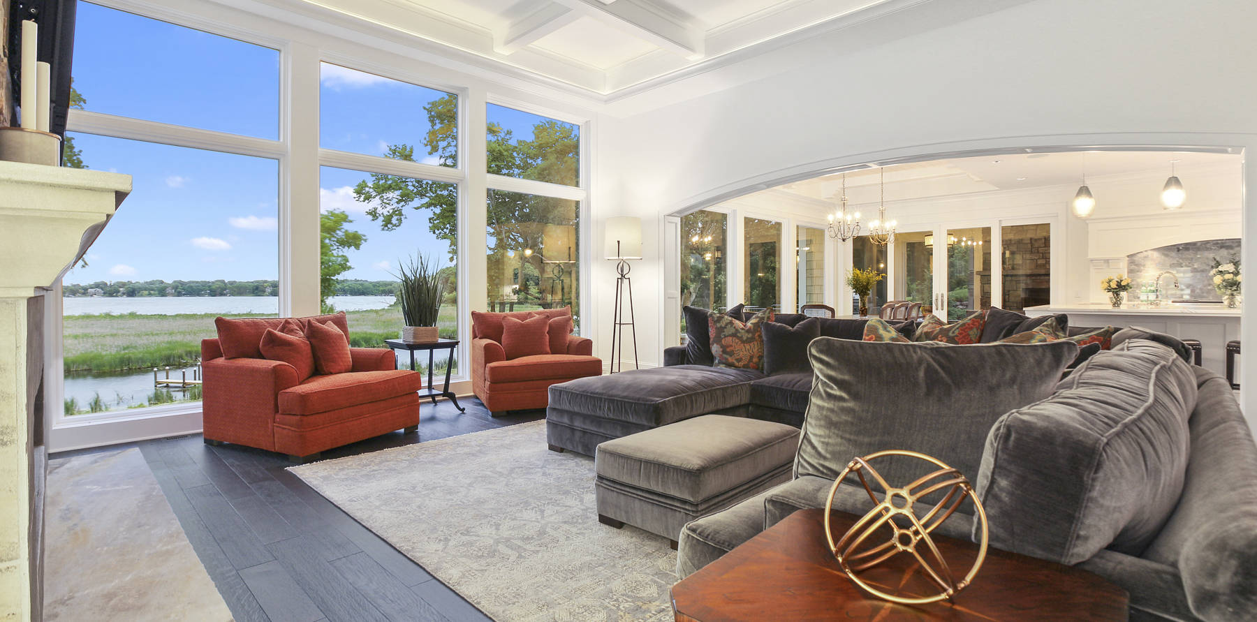 Large mansion with lighted coffered ceiling and archway leading to kitchen